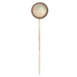 AN ANTIQUE MAN IN THE MOON RAINBOW MOONSTONE TIE PIN in yellow gold and gilt metal, set with a