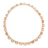AN ANTIQUE IMPERIAL TOPAZ RIVIERE NECKLACE, 19TH CENTURY in yellow gold, comprising of thirty oval