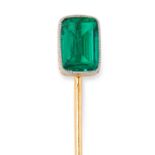 A COLOMBIAN EMERALD STICK / TIE PIN in high carat yellow gold, set with an emerald cut emerald of