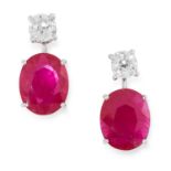 A PAIR OF RUBY AND DIAMOND EARRINGS in high carat white gold, each set with an oval cut ruby below a