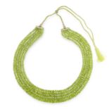 A FIVE ROW PERIDOT BEAD NECKLACE comprising of five rows of graduated faceted peridot beads