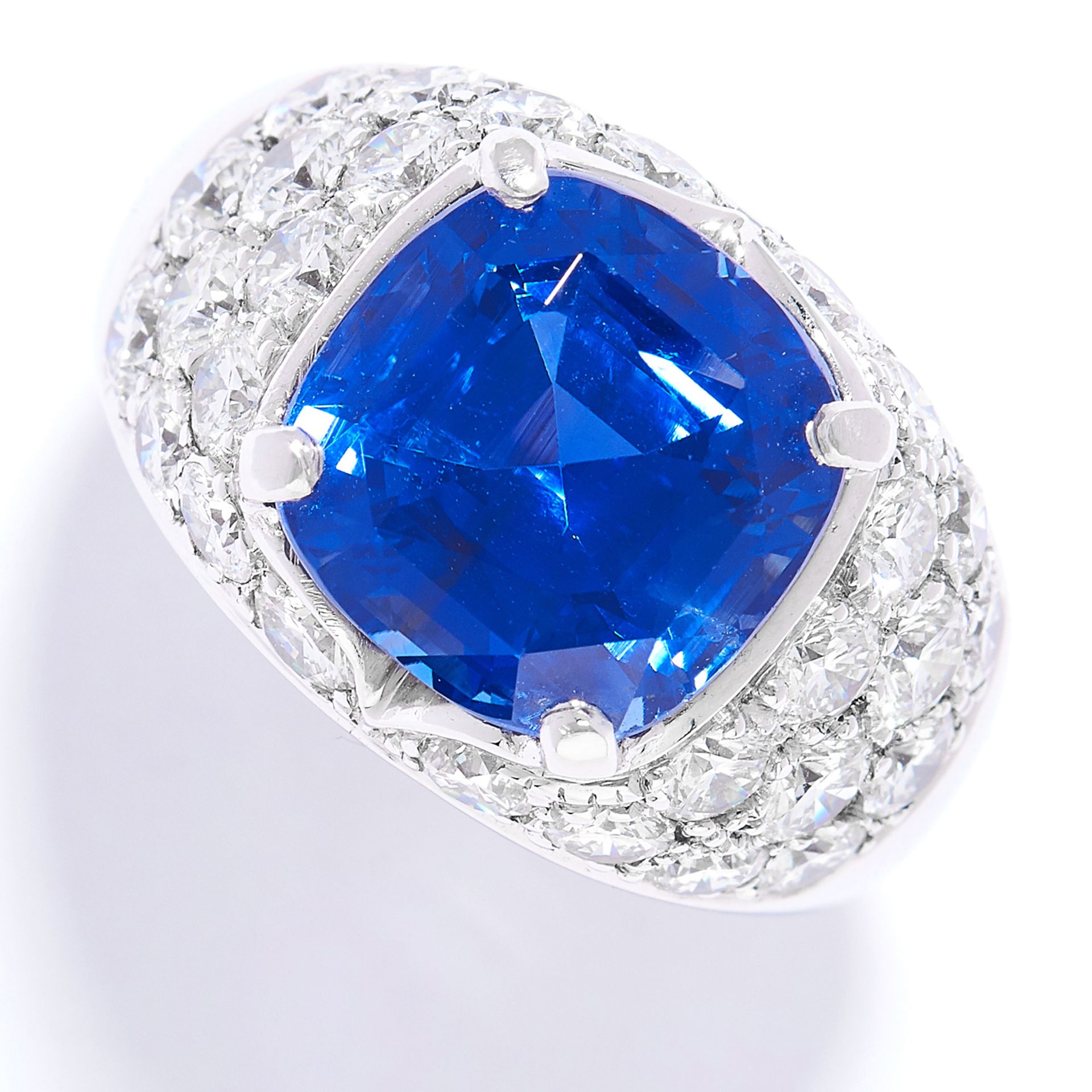 A 9.46 CARAT SAPPHIRE AND DIAMOND RING in 18ct white gold, set with a central cushion cut sapphire