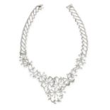A DIAMOND COLLAR NECKLACE in 18ct white gold, in scrolling open framework design set with round