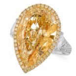 A 10.04 FANCY YELLOW DIAMOND AND WHITE DIAMOND RING set with a central pear cut diamond of 10.04