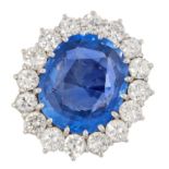 A CEYLON NO HEAT SAPPHIRE AND DIAMOND CLUSTER RING, BOODLES in 18ct white gold, set with an oval cut