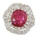 A RUBY AND DIAMOND CLUSTER RING set with a oval cu