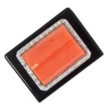 A CORAL, ONYX AND DIAMOND DRESS RING set with a rectangular polished onyx with a central polished