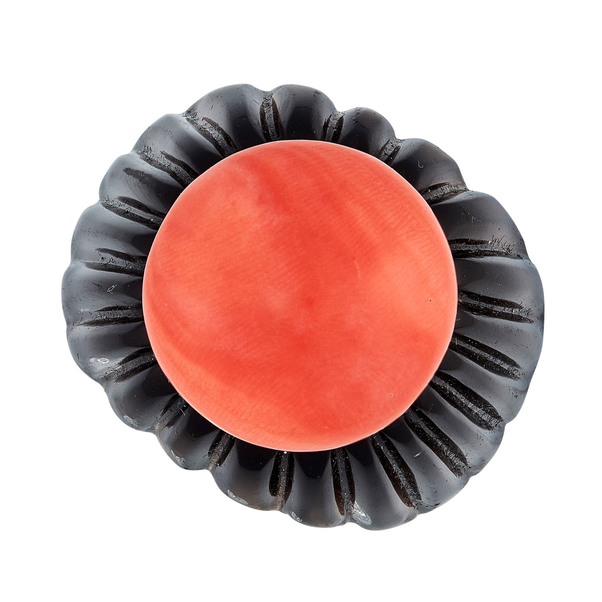 AN ONYX AND CORAL DRESS RING comprising of a carved onyx shank set with a central coral cabochon,