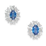 A PAIR OF SAPPHIRE AND DIAMOND CLUSTER EARRINGS set with an oval modern brilliant cut sapphire in