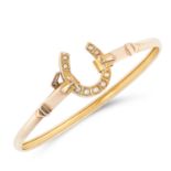 AN ANTIQUE PEARL HORSESHOE BANGLE in 9ct yellow gold, comprising of a gold bangle set with a