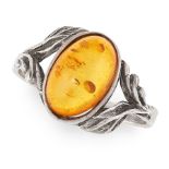 AN ART NOUVEAU AMBER DRESS RING in sterling silver, set with an oval amber cabochon between