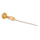 AN ANTIQUE CITRINE TIE / STICK PIN in 9ct yellow gold, set at the end with an oval cut citrine