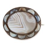 AN ANTIQUE SCOTTISH AGATE BROOCH in silver, set with an oval agate cabochon within a border of
