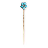 AN ANTIQUE TURQUOISE AND RUBY FORGET-ME-NOT TIE PIN in yellow gold, the stick pin set with a