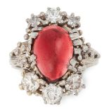 A VINTAGE GARNET AND DIAMOND RING, 1976 in 18ct white gold, set with an antique garnet cabochon