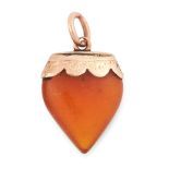 AN ANTIQUE AMBER HEART PENDANT in yellow gold, carved to depict a heart, with engraved mounting,