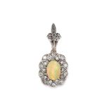 AN OPAL AND DIAMOND PENDANT in yellow and white gold, comprising of a large cabochon opal in a