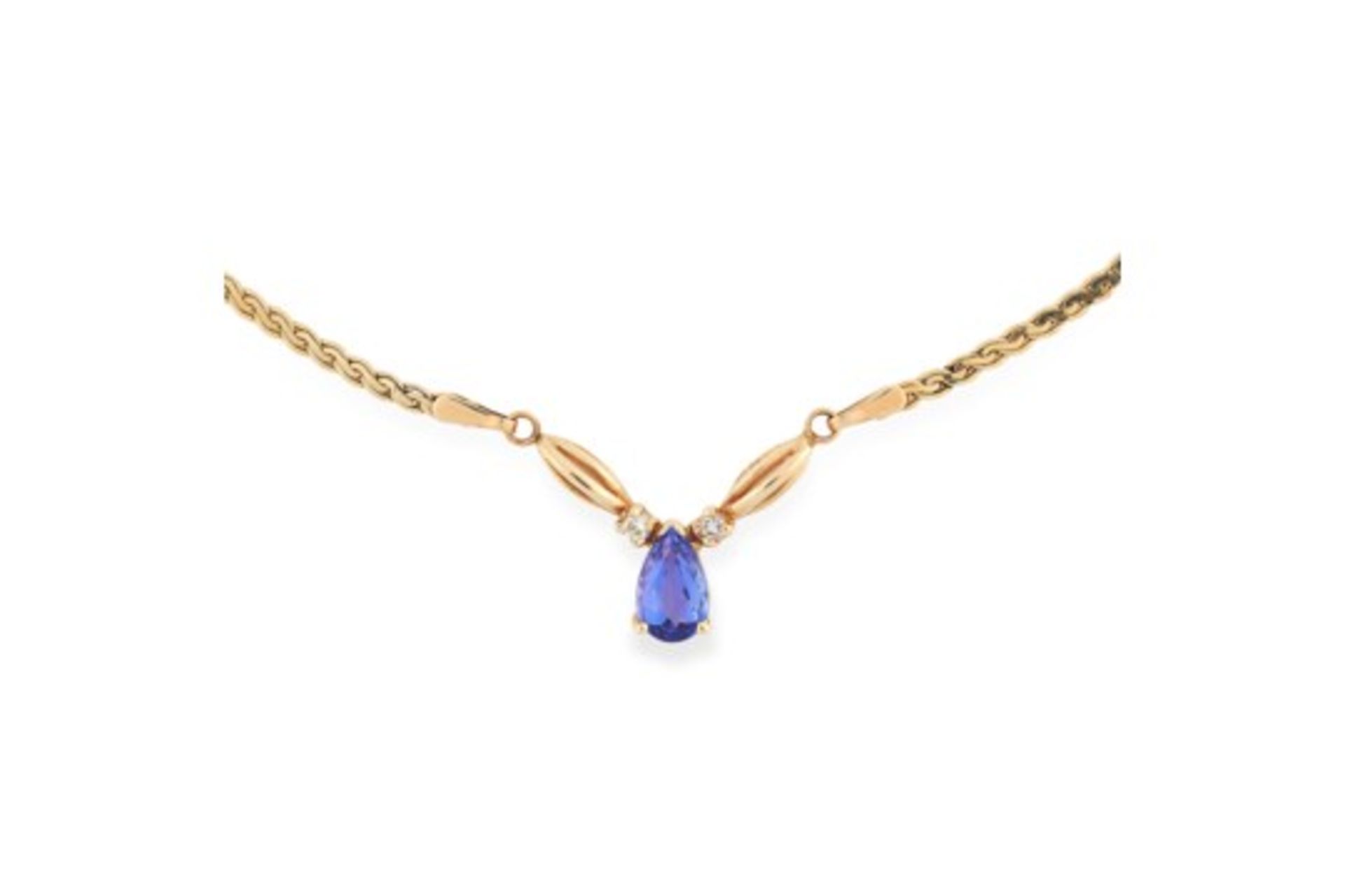 TANZANITE AND DIAMOND PENDANT NECKLACE set with a pear cut tanzanite between two round cut diamonds,
