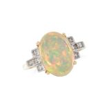 AN OPAL AND DIAMOND DRESS RING set with a cabochon opal between round cut diamonds, British