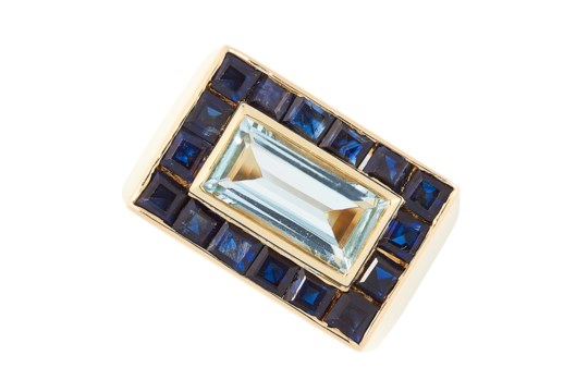 A SAPPHIRE AND BLUE TOPAZ DRESS RING, MURUNI set with a central step cut blue topaz in a border of