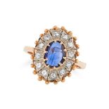 A SAPPHIRE AND DIAMOND CLUSTER RING set with an oval rose cut sapphire in a cluster of round