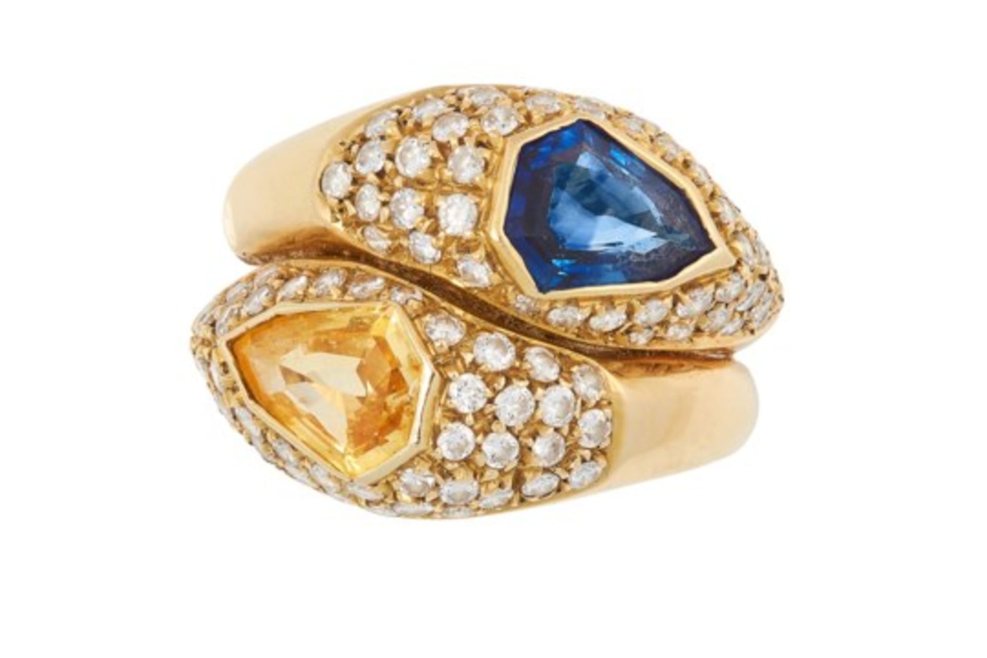 A BLUE SAPPHIRE, YELLOW SAPPHIRE AND DIAMOND CROSSOVER RING set with a fancy cut yellow sapphire,