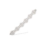 A DIAMOND BRACELET in platinum, in Art Deco design, comprising of six principal openwork links set