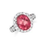 A PINK TOURMALINE AND DIAMOND DRESS RING, set with a faceted oval cut tourmaline and round cut