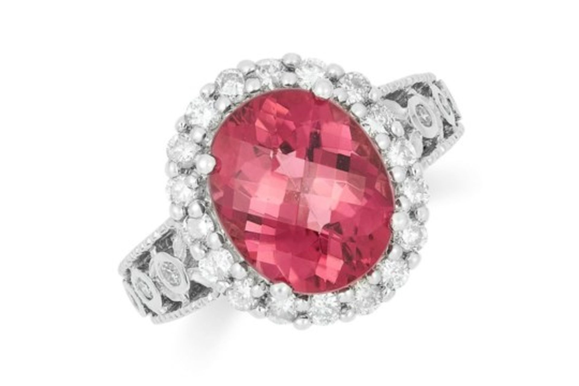 A PINK TOURMALINE AND DIAMOND DRESS RING, set with a faceted oval cut tourmaline and round cut