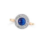 A SAPPHIRE AND DIAMOND CLUSTER RING set with a round cut sapphire in a border of rose cut