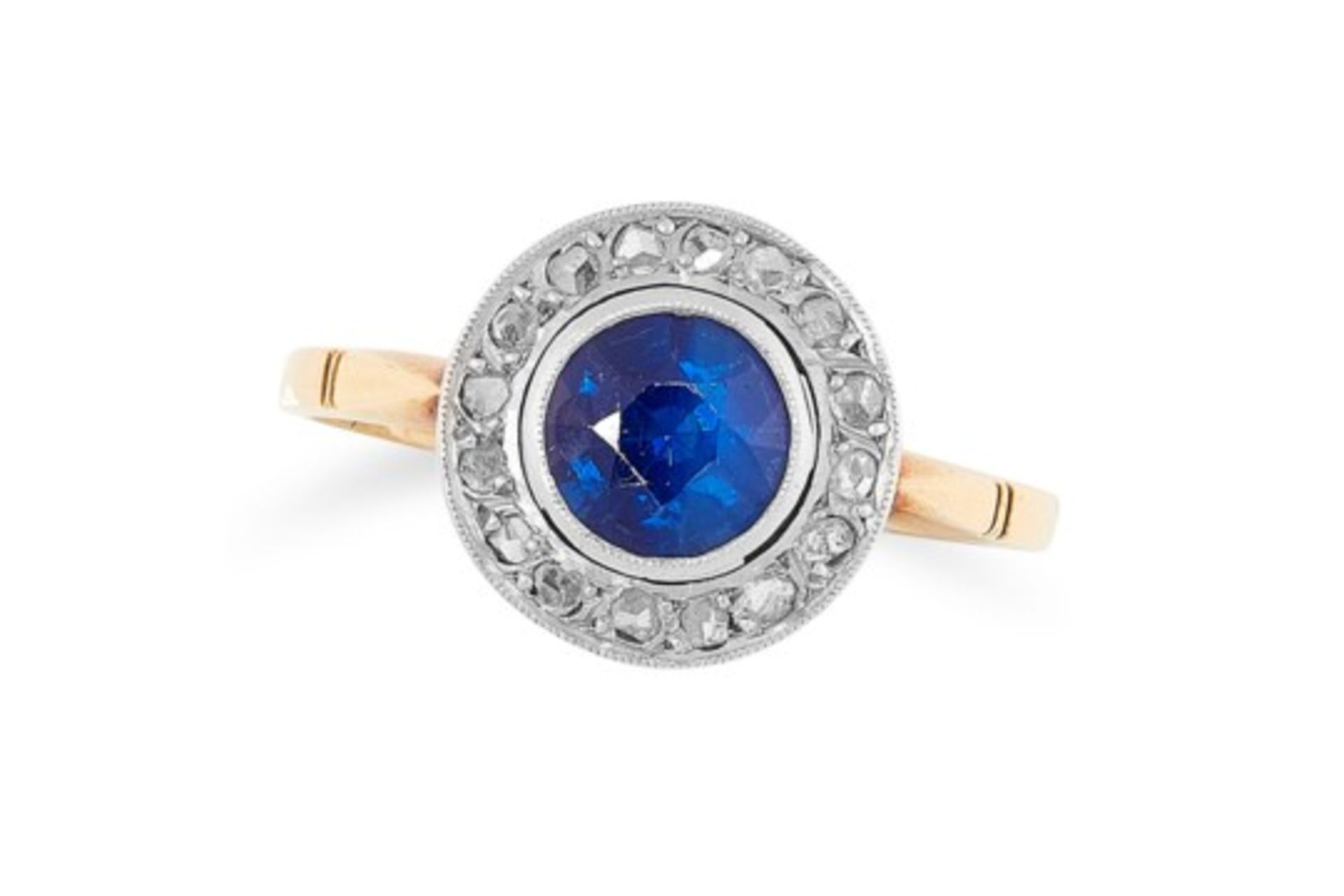 A SAPPHIRE AND DIAMOND CLUSTER RING set with a round cut sapphire in a border of rose cut