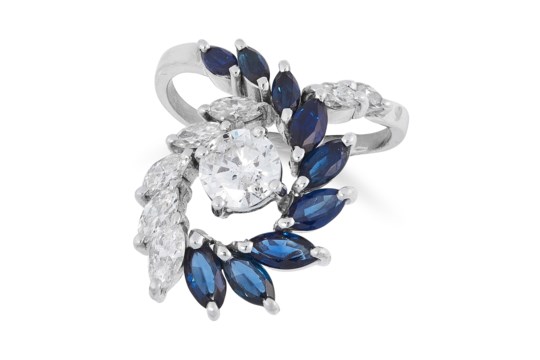 A DIAMOND AND SAPPHIRE DRESS RING set with a central round cut diamond of 1.0 carats, accented by