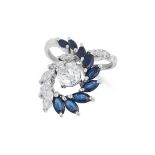A DIAMOND AND SAPPHIRE DRESS RING set with a central round cut diamond of 1.0 carats, accented by