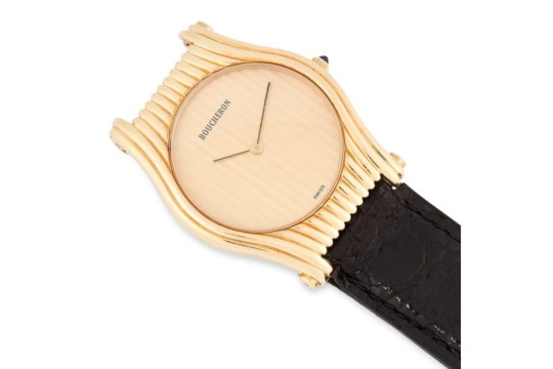 A LADIES WRIST WATCH, BOUCHERON in yellow gold, with gold dial and black leather strap, signed