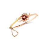 AN ANTIQUE DIAMOND, PEARL AND ENAMEL BANGLE in yellow gold, comprising of a flower jewelled with