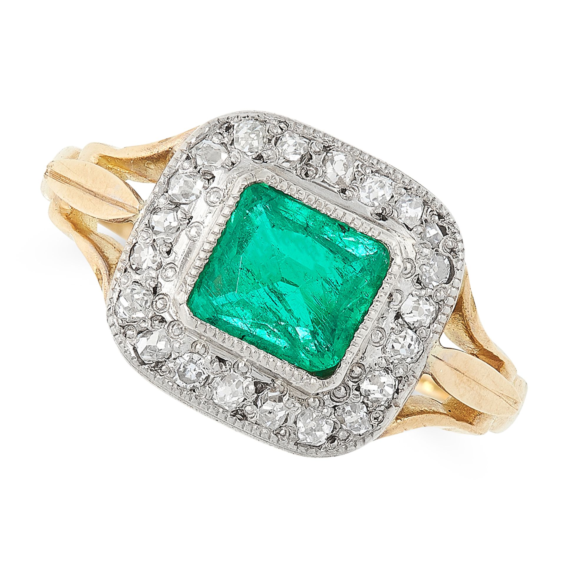 AN EMERALD AND DIAMOND RING in 18ct yellow gold, set with a mixed cut emerald within a border of