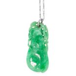 AN ANTIQUE CHINESE JADEITE JADE PENDANT comprising a carved and polished piece of jadeite
