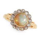 AN ANTIQUE OPAL AND DIAMOND RING in yellow gold and silver, set with a circular cabochon opal within