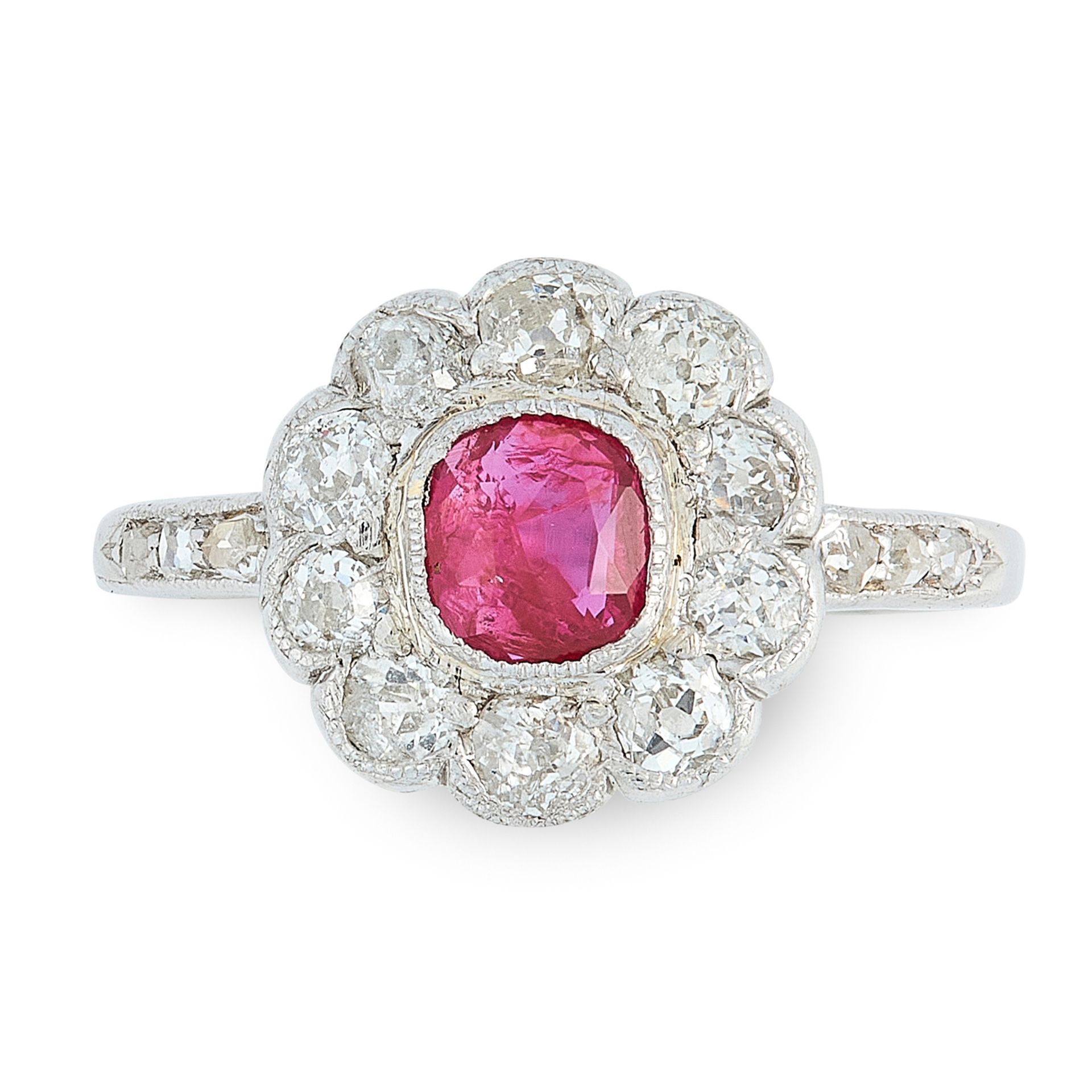 A RUBY AND DIAMOND CLUSTER RING set with a central cushion ruby of 0.50 carats within a border of