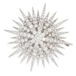 A DIAMOND BROOCH designed as a sunburst motif, set with a central round cut diamond of 0.65