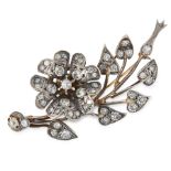 A DIAMOND EN TREMBLANT SPRAY BROOCH in yellow gold and silver, designed as a floral spray, with en