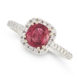 A RUBY AND DIAMOND RING in 18ct white gold, set with a cushion cut ruby of 1.15 carats, within a