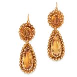 A PAIR OF ANTIQUE CITRINE EARRINGS in 18ct yellow gold, each set with a pear cut citrine within