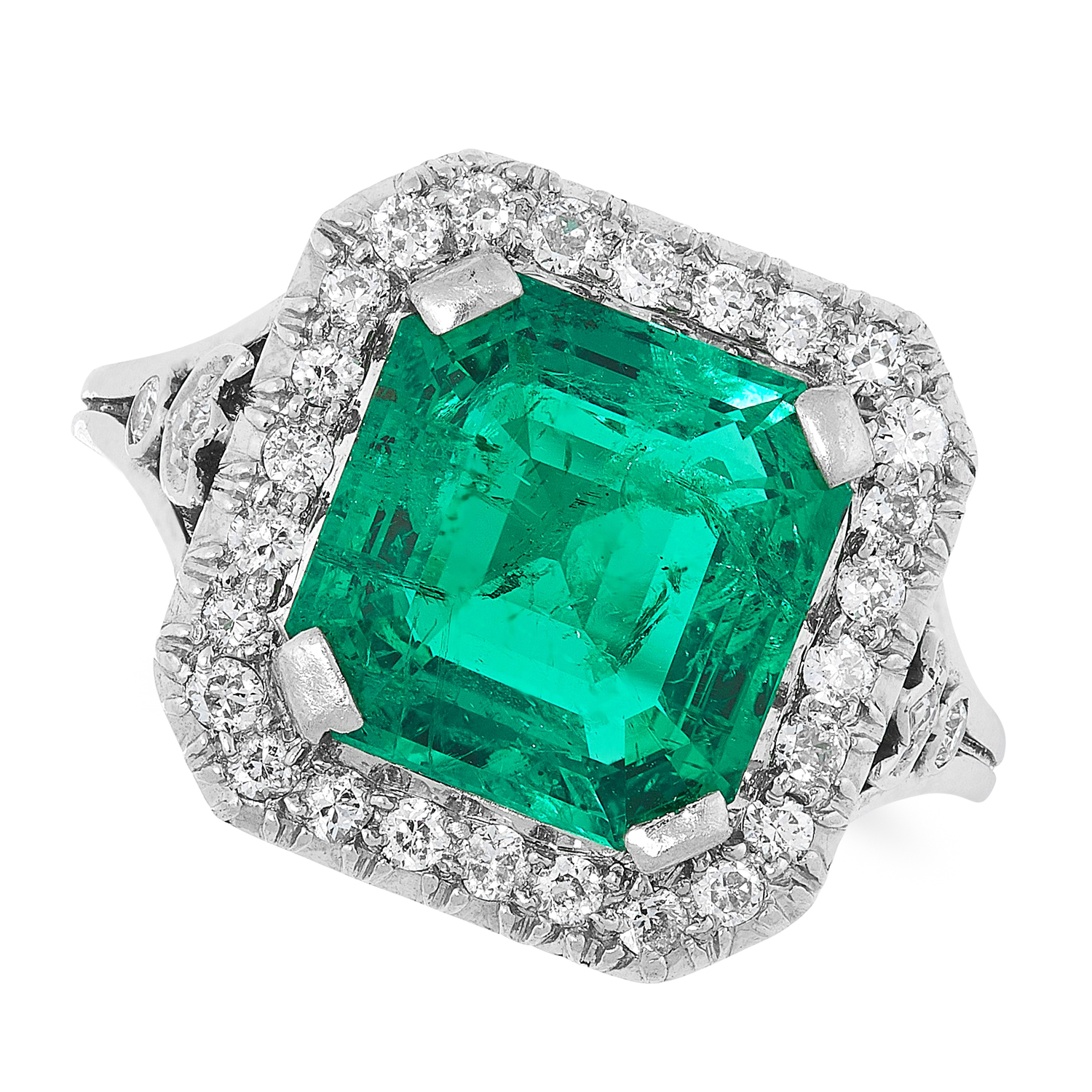 A COLOMBIAN EMERALD AND DIAMOND CLUSTER RING set with an emerald cut emerald of 2.84 carats in a