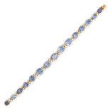 A SAPPHIRE AND DIAMOND BRACELET in yellow gold, comprising a row of fifteen graduated oval cut