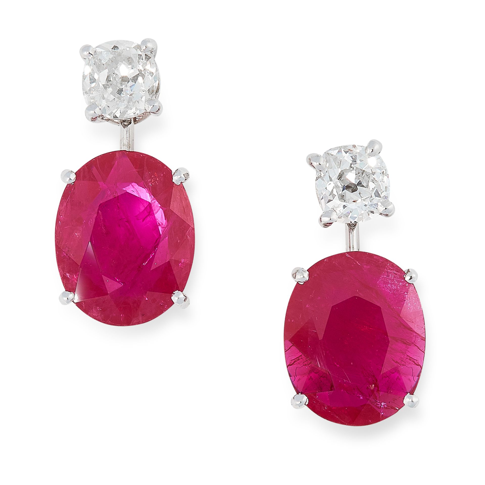 A PAIR OF RUBY AND DIAMOND EARRINGS in high carat white gold, each set with an oval cut ruby below a