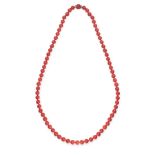 AN EXCEPTIONAL CORAL BEAD AND DIAMOND SAUTOIR NECKLACE comprising a single row of seventy-one