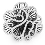 A DIAMOND COCKTAIL RING in 18ct white gold, the articulated scrolling motifs designed to depict a