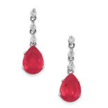 A PAIR OF RUBY AND DIAMOND DROP EARRINGS in platinum, each set with a pear cut ruby below a trio