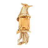 A VINTAGE CITRINE BIRD BROOCH in high carat yellow gold, designed as a bird seated atop a perch,